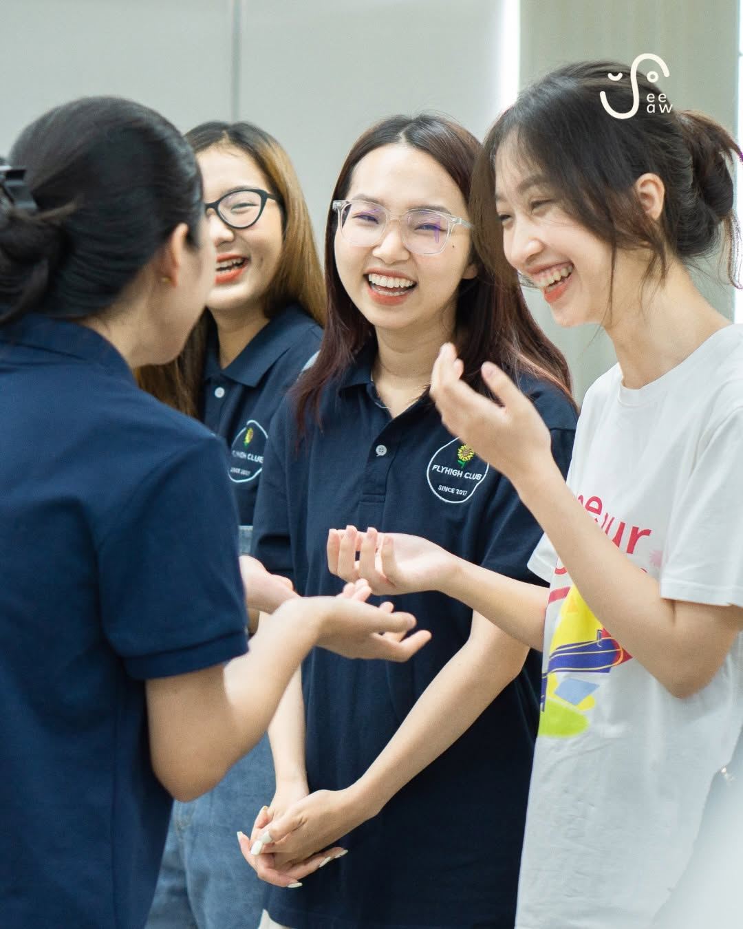 A group laughing together during a SeeSaw community session